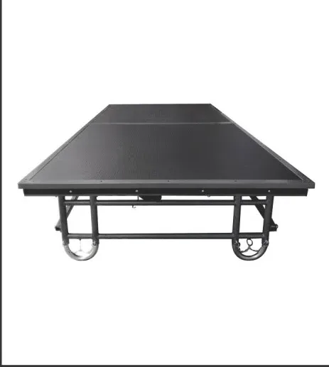 Black-top foldable stage opened flat on its wheeled folding frame