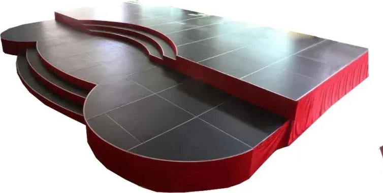 Guitar-shaped black stage with red skirt and curved steps