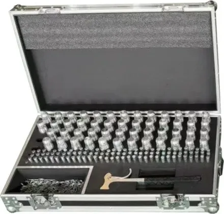 Open flight case with foam insert organizing rows of spigot coupler hardware and a hammer