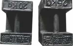 Two cast iron counterweight blocks with handles